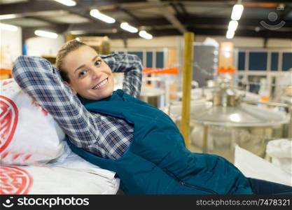 happy blond woman relaxing in factory