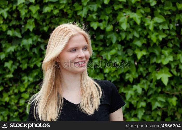 Happy blonde girl outside sunrounded many flower