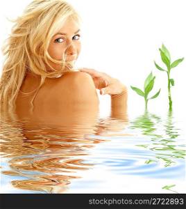 happy blonde in water with green plants