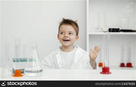 happy boy scientist laboratory with test tubes