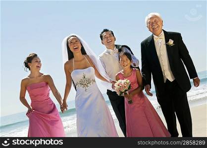 Happy Bride and Groom With Family on Beach