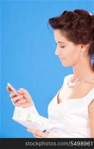 happy bride with calculator and money over blue