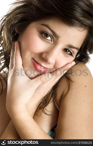Happy brunette girl holding her face