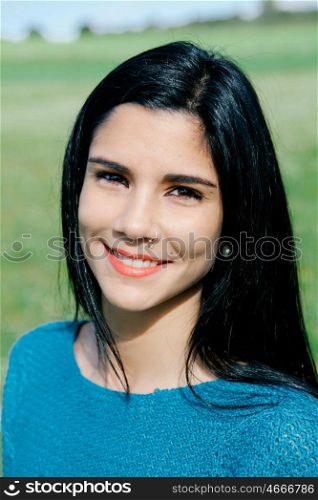Happy brunette girl smiling in the field