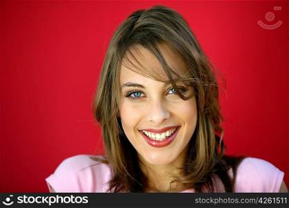 Happy brunette on red background