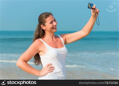 happy brunette photographed yourself on the beach in the afternoon
