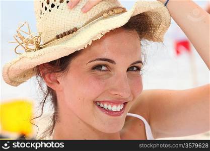 Happy brunette wearing straw hat