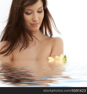 happy brunette with yellow lily flowers in water