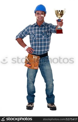 Happy builder holding trophy