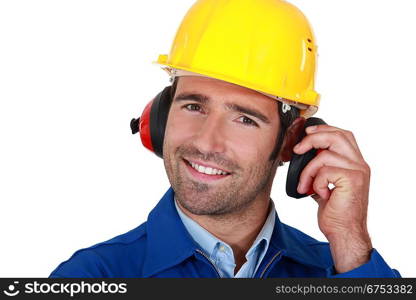 Happy builder wearing ear protection