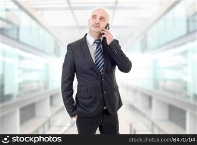 happy business man on the phone, at the office. calling