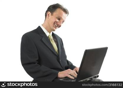 Happy business man working on his laptop with a smile on his face