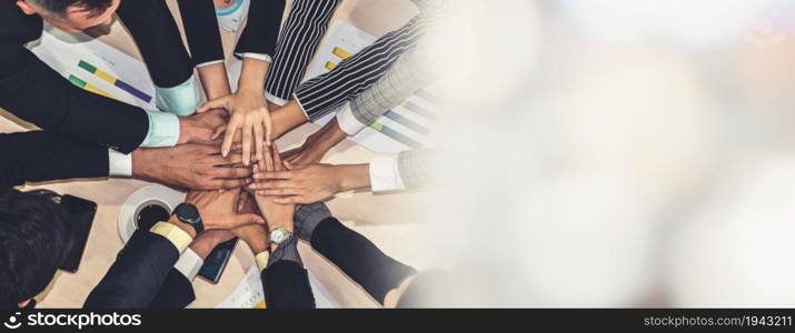 Happy business people celebrate teamwork success together with joy at office table shot from top view . Young businessman and businesswoman workers express cheerful victory in broaden view .. Happy business people celebrate teamwork success broaden view