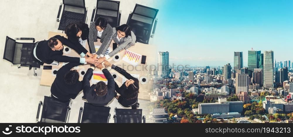 Happy business people celebrate teamwork success together with joy at office table shot from top view . Young businessman and businesswoman workers express cheerful victory in broaden view .. Happy business people celebrate teamwork success broaden view