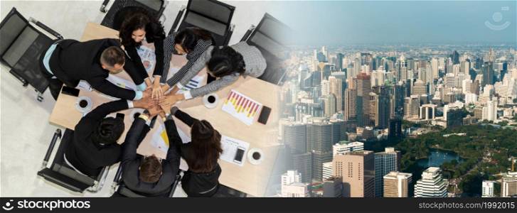 Happy business people celebrate teamwork success together with joy at office table shot from top view . Young businessman and businesswoman workers express cheerful victory in broaden view .. Happy business people celebrate teamwork success broaden view