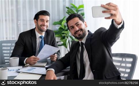 Happy business snapping selfie at office desk after finishing paperwork. Smiling and having fun as friendship and teamwork concept. Professional and friendly environment in workplace. Fervent. Happy business snapping selfie at office desk after finishing paperwork. Fervent
