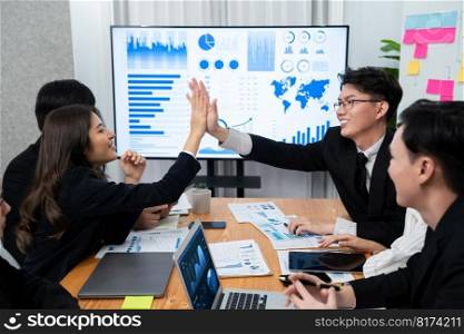 Happy business team office worker making high five with each other and celebrate after successful meeting in office workplace, business agreement to promote harmony and strong teamwork concept.. Happy office worker making high five with each other in harmony workplace.