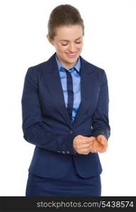 Happy business woman adjusting cuff