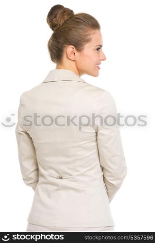 Happy business woman looking on copy space . rear view