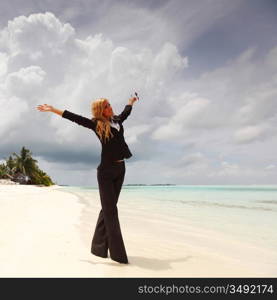 happy business woman on the desolate ocean coast