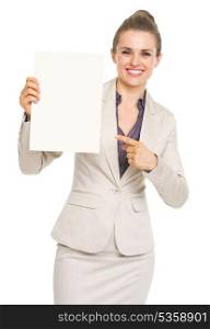 Happy business woman pointing on blank paper sheet