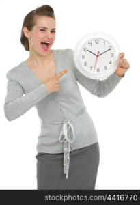 Happy business woman pointing on clock