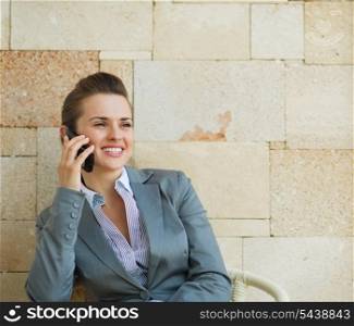 Happy business woman speaking mobile phone