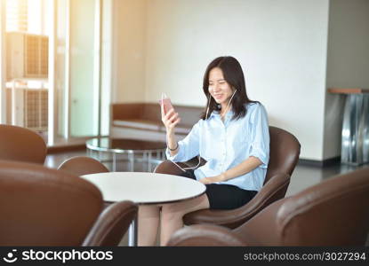 Happy business woman talking on the phone in living room