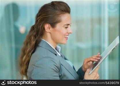 Happy business woman using tablet PC