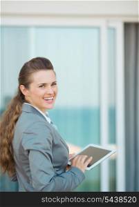 Happy business woman with tablet pc on terrace