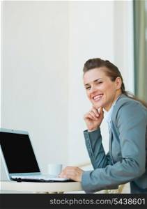 Happy business woman working on laptop