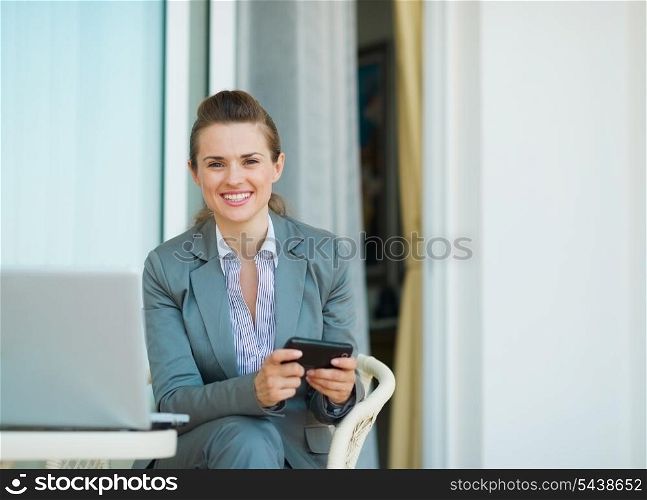Happy business woman writing text message