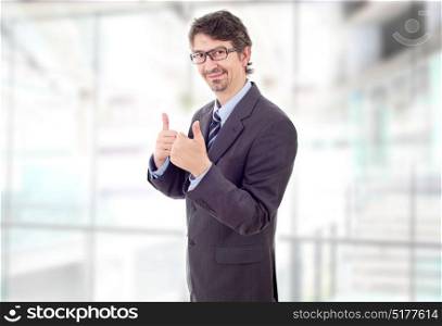 happy businessman going thumb up, at the office