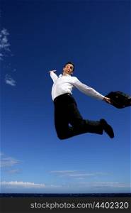Happy businessman jumping in field
