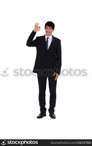 Happy businessman making OK gesture