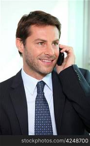 Happy businessman on phone