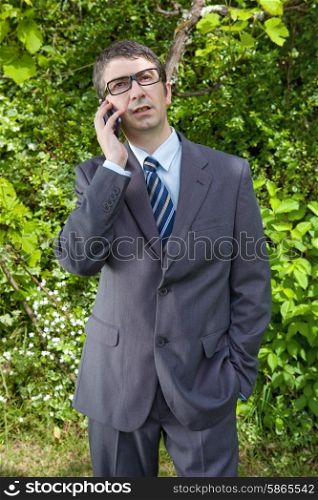 Happy businessman outdoor talking through mobile phone
