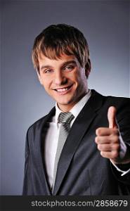 Happy businessman showing his thumb up with smile
