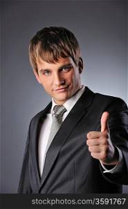 Happy businessman showing his thumb up with smile