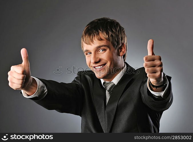 Happy businessman showing his thumbs up with smile