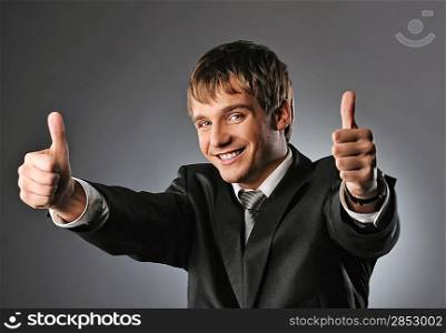 Happy businessman showing his thumbs up with smile