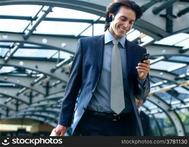 happy businessman talking on mobile phone in airport
