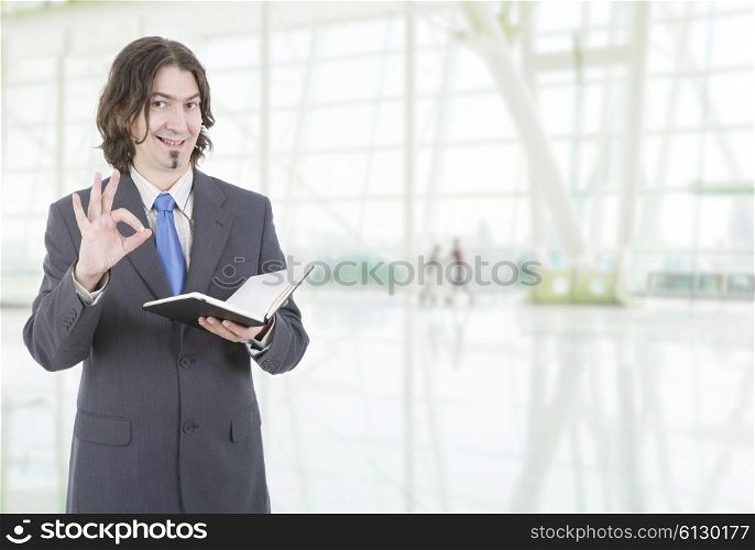 happy businessman with a book at the office