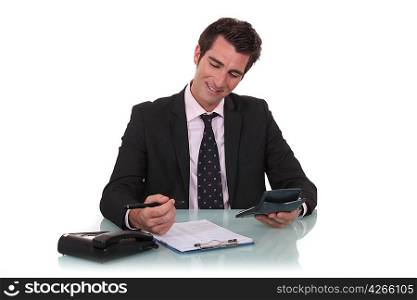 Happy businessman with a calculator