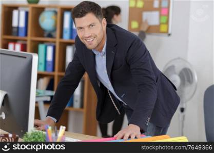happy businessman with a computer in an office