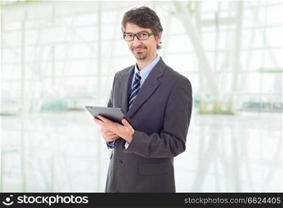 happy businessman with a tablet pc, at the office