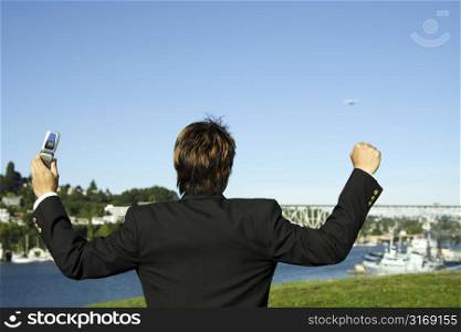 Happy businessman with arms up in the air