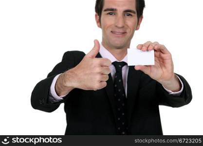 Happy businessman with card