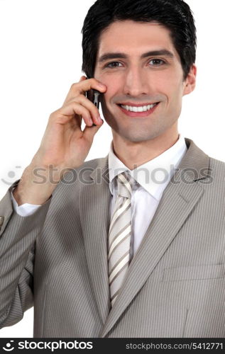 Happy businessman with mobile telephone