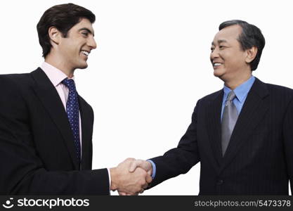 Happy businessmen shaking hands over white background